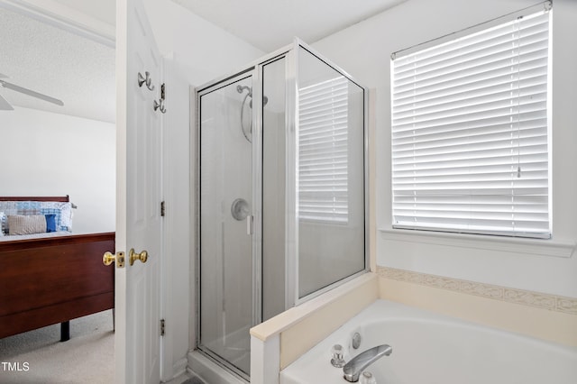 bathroom with a garden tub, a ceiling fan, a stall shower, a textured ceiling, and ensuite bath