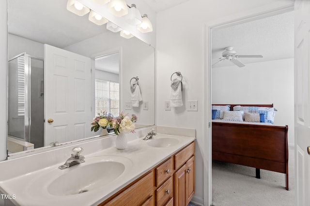 bathroom featuring double vanity, a sink, a shower stall, and ensuite bathroom