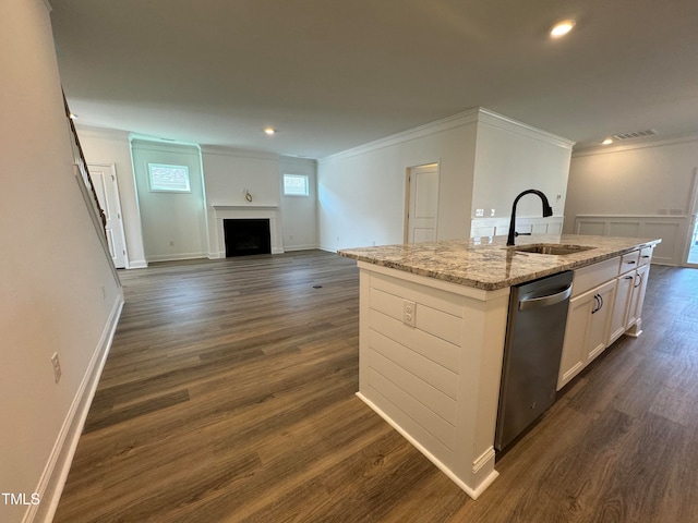 kitchen with stainless steel dishwasher, white cabinets, dark hardwood / wood-style flooring, and an island with sink