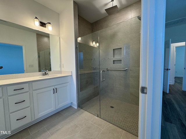 bathroom featuring an enclosed shower, vanity, and tile patterned floors