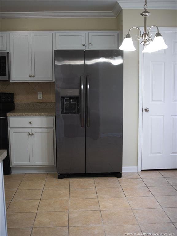 kitchen featuring white cabinets, stainless steel appliances, and hanging light fixtures