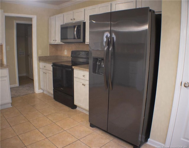 kitchen featuring white cabinets, light tile patterned flooring, ornamental molding, and appliances with stainless steel finishes