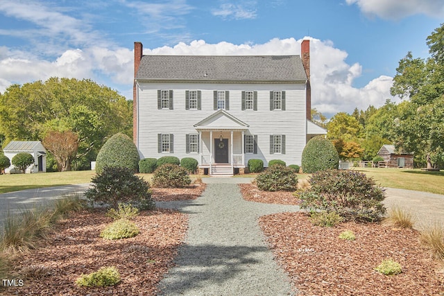 colonial house featuring a front yard and a porch