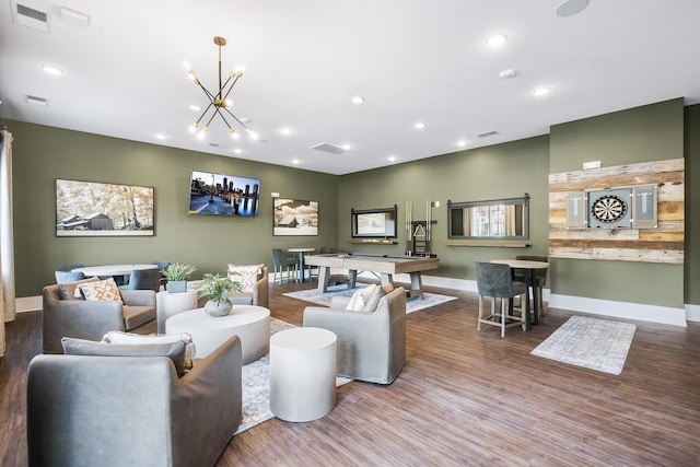living room with recessed lighting, visible vents, wood finished floors, and a chandelier