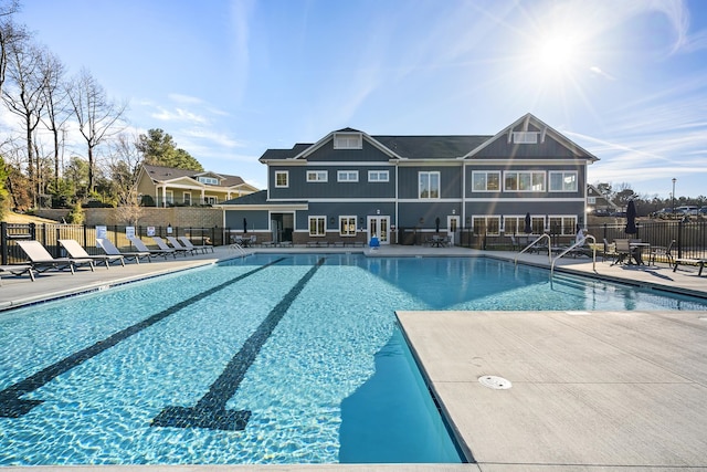 community pool featuring fence and a patio area