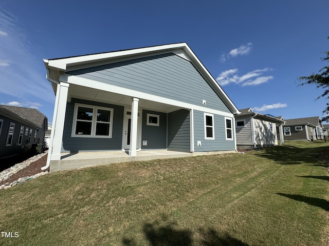 back of house with a lawn