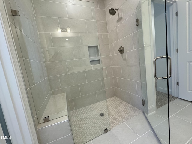 bathroom featuring tile patterned flooring and a shower stall
