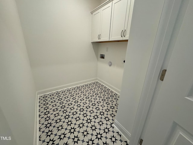 laundry room featuring washer hookup, light tile patterned flooring, and cabinets