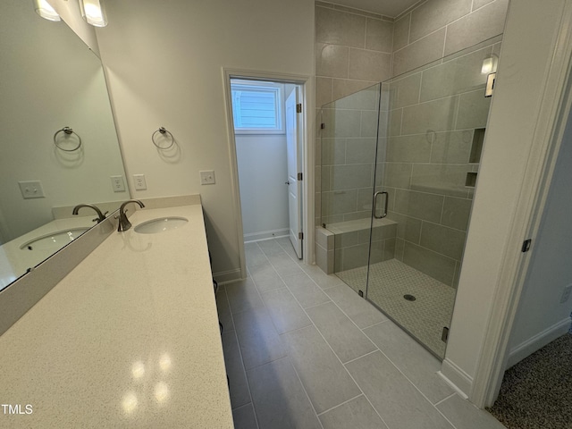 full bath with a shower stall, vanity, and baseboards