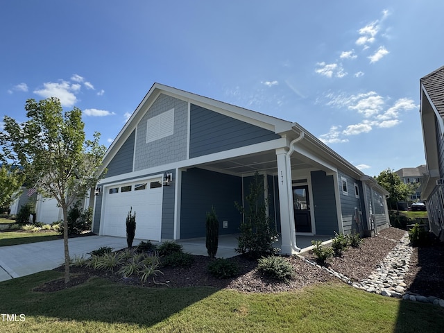 exterior space featuring covered porch, driveway, and a yard