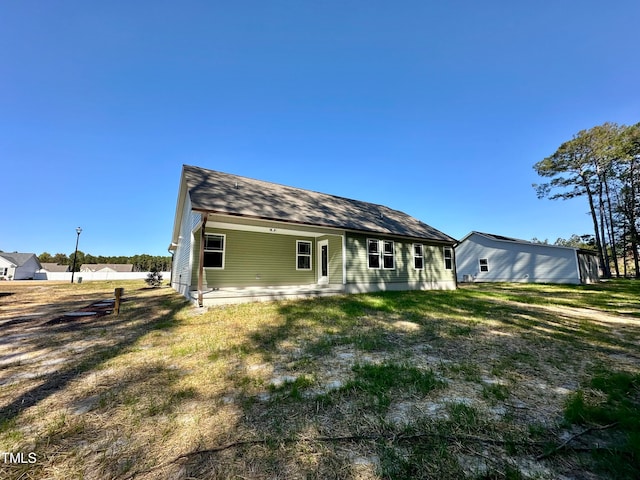 back of house with a lawn