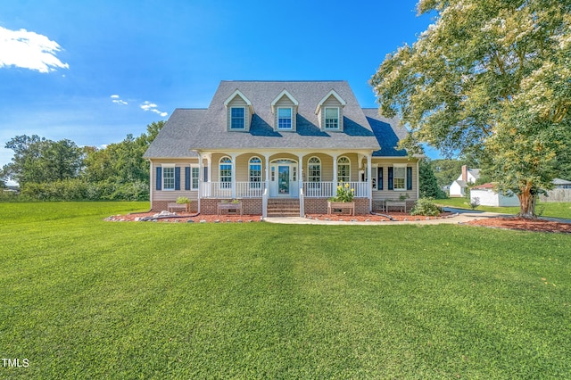 cape cod home with covered porch, a front lawn, and roof with shingles