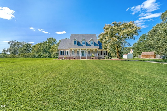 cape cod-style house with crawl space, covered porch, a shingled roof, and a front yard