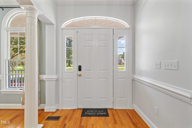 entryway featuring visible vents, decorative columns, light wood-style flooring, and baseboards