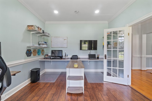 home office featuring built in desk, hardwood / wood-style flooring, and crown molding