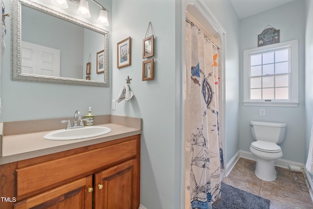 bathroom with curtained shower, tile patterned flooring, toilet, vanity, and baseboards