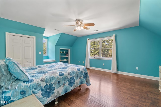 bedroom featuring lofted ceiling, baseboards, visible vents, and wood finished floors