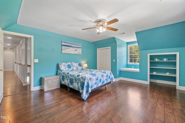 bedroom featuring a ceiling fan, a closet, baseboards, and hardwood / wood-style flooring