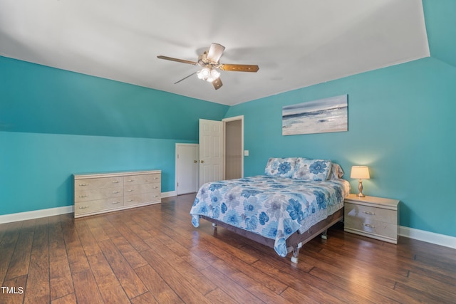 bedroom featuring lofted ceiling, baseboards, and hardwood / wood-style floors