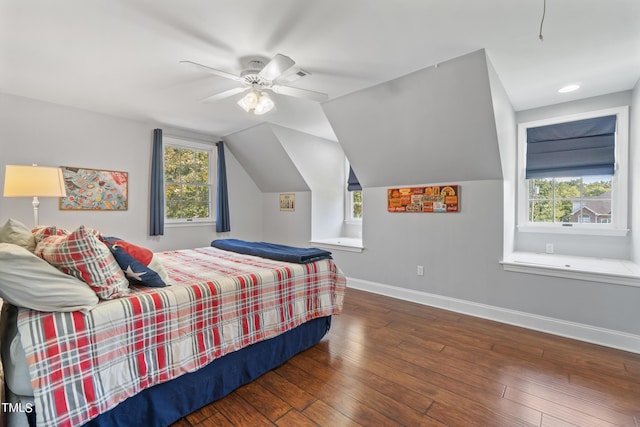 bedroom with multiple windows, hardwood / wood-style flooring, and baseboards