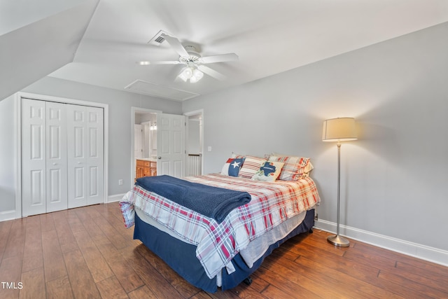 bedroom with attic access, baseboards, ceiling fan, hardwood / wood-style floors, and a closet