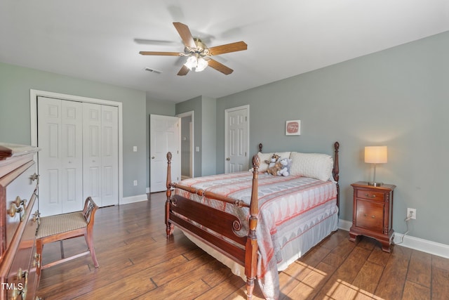 bedroom featuring ceiling fan, visible vents, baseboards, and wood finished floors