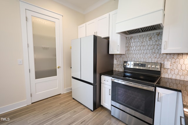 kitchen with custom exhaust hood, light hardwood / wood-style flooring, tasteful backsplash, white cabinetry, and stainless steel electric range oven