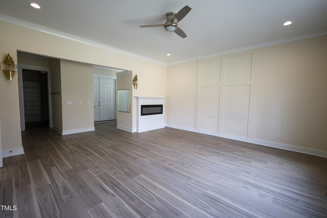 unfurnished living room featuring ceiling fan, crown molding, and hardwood / wood-style floors