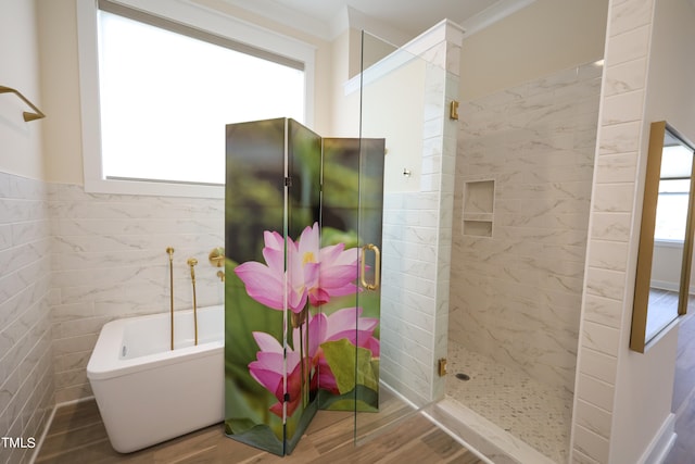 bathroom with tile walls and separate shower and tub