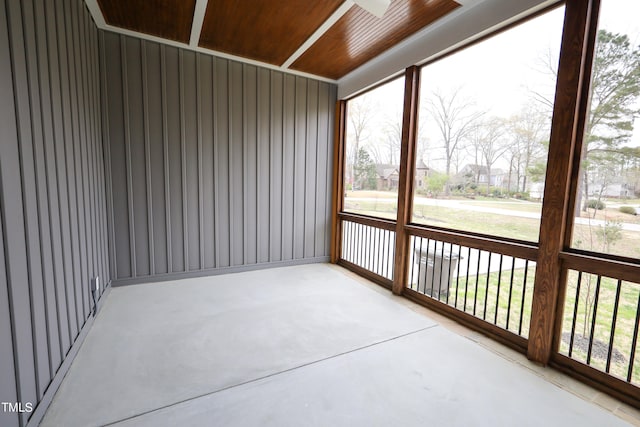 unfurnished sunroom featuring wooden ceiling and a healthy amount of sunlight