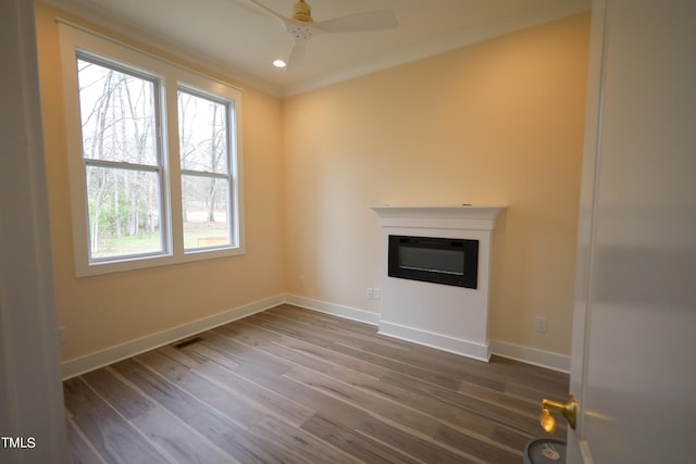 unfurnished living room with ceiling fan, hardwood / wood-style flooring, and crown molding