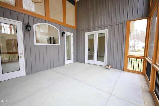 unfurnished sunroom with french doors and a healthy amount of sunlight