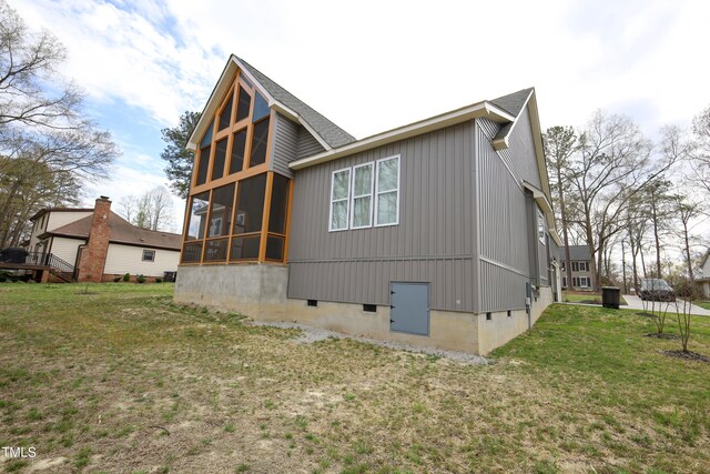 back of house featuring a sunroom and a yard