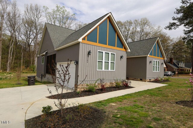 view of front of property with a front lawn and a garage