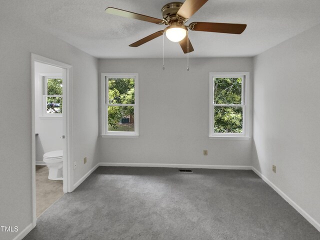 spare room featuring ceiling fan, a textured ceiling, and carpet flooring