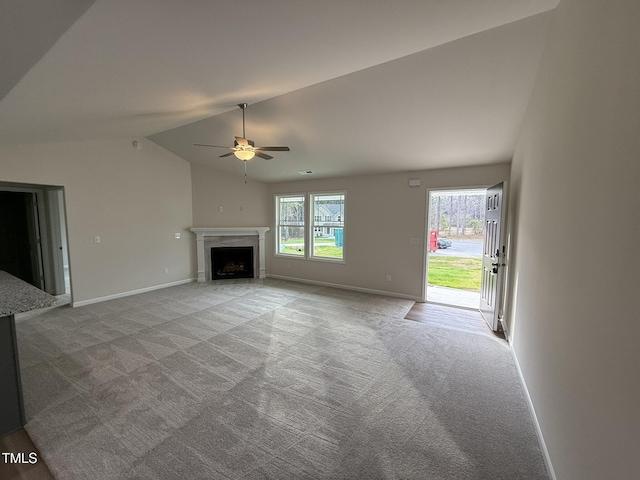 unfurnished living room with ceiling fan, light carpet, and lofted ceiling