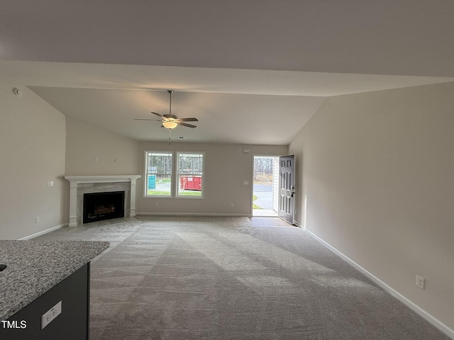 unfurnished living room with carpet flooring, ceiling fan, and lofted ceiling