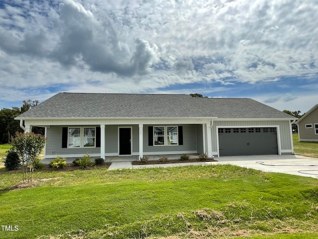 view of front facade with a garage, a front lawn, and covered porch