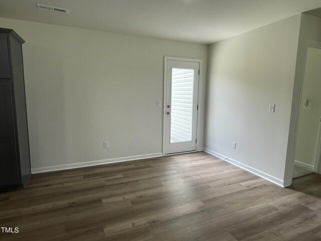 empty room with wood-type flooring