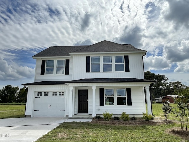view of front facade with driveway, a shingled roof, a garage, and a front yard