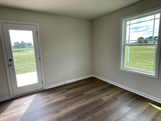 spare room with dark hardwood / wood-style flooring