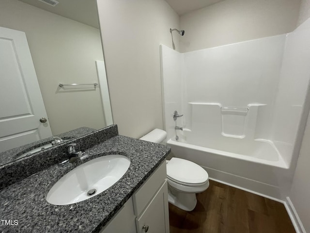 full bathroom featuring tub / shower combination, visible vents, wood finished floors, toilet, and vanity