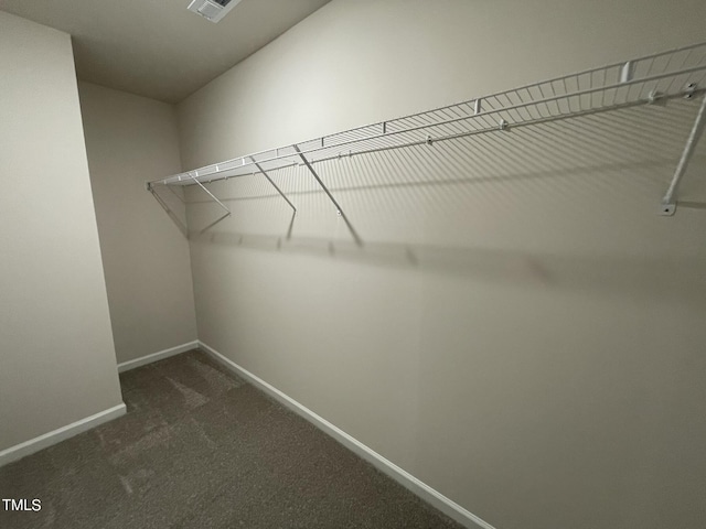 walk in closet with dark carpet and visible vents
