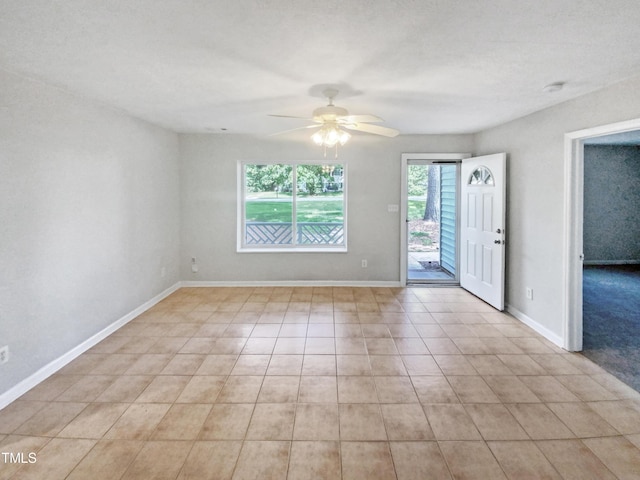 unfurnished room with ceiling fan and baseboards