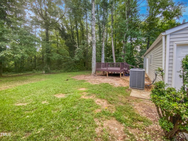 view of yard with cooling unit and a wooden deck