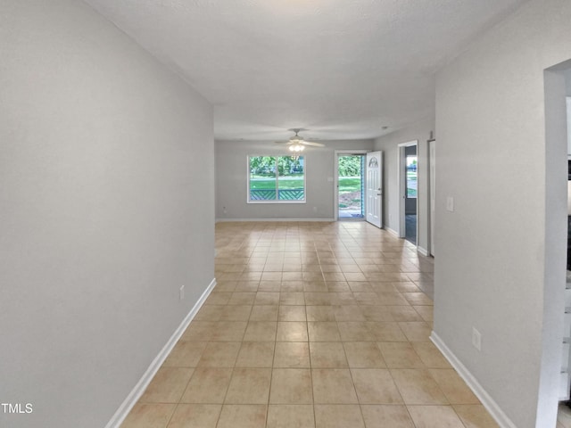 interior space featuring baseboards and light tile patterned floors