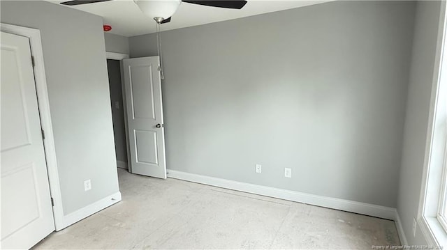 unfurnished bedroom with a ceiling fan and baseboards