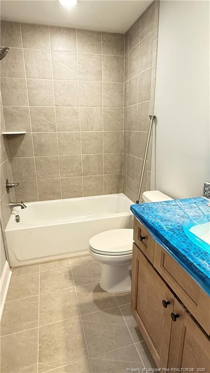 full bath with tile patterned flooring, shower / bathing tub combination, vanity, and toilet