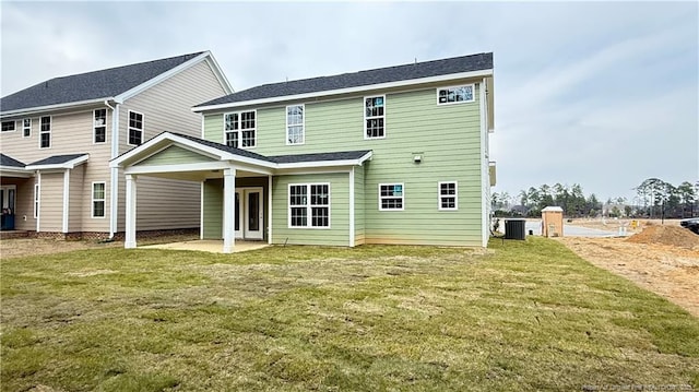 back of house with a yard and a patio area