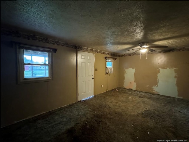 foyer with a textured ceiling and ceiling fan